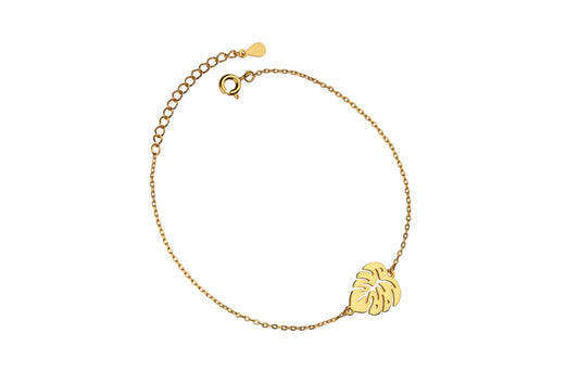 A gold-plated bracelet featuring a palm leaf charm, with an adjustable chain and a lobster clasp closure.
