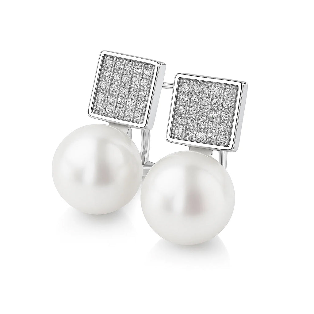 Pearl earrings with zirconia-studded square caps on a white background