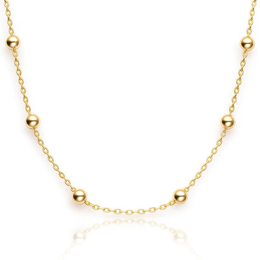 Gold necklace with beads on a white background