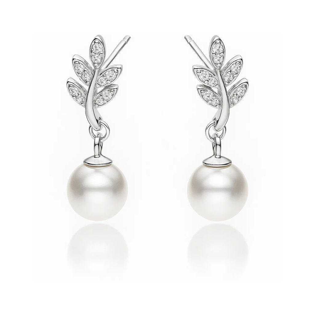 Pair of earrings with pearl drops and leaf-like designs on a white background
