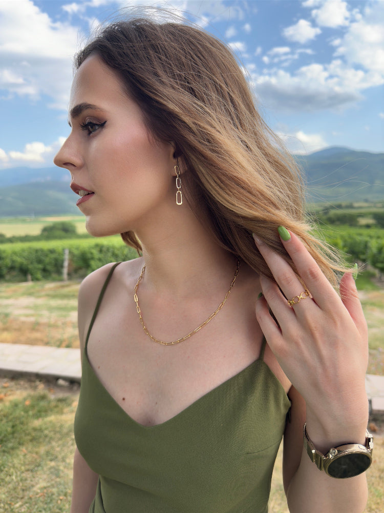 Woman in a green dress with jewelry outdoors