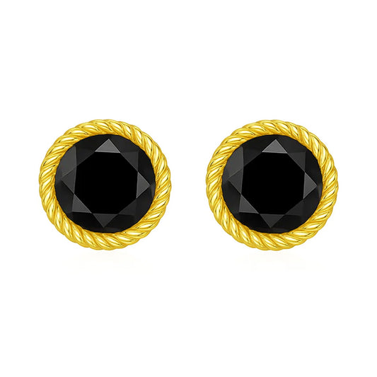 Pair of gold earrings with black gemstones on a white background