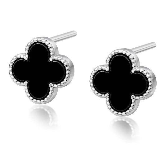 Pair of clover-shaped earrings with black centers and silver borders on a white background