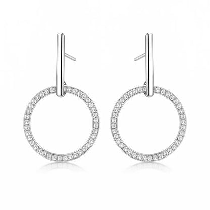 Pair of silver hoop earrings with small zirconia on a white background