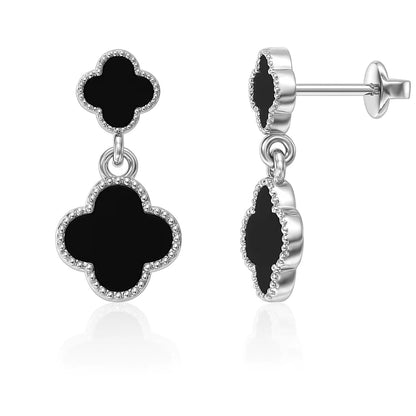 Black clover-shaped earrings with silver detailing on a white background