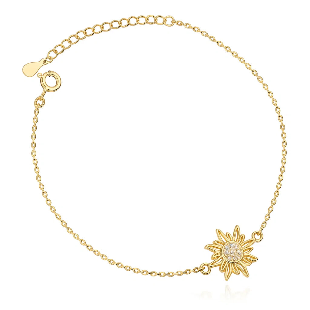 Gold bracelet with sunflower charm on a white background