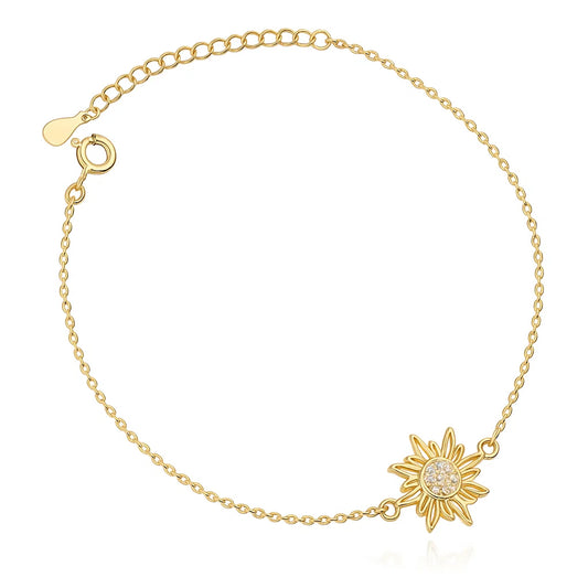 Gold bracelet with sunflower charm on a white background