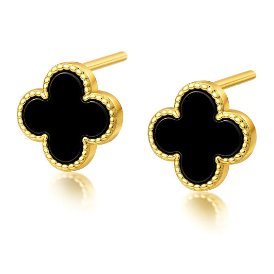 Gold and black clover-shaped earrings on a white background