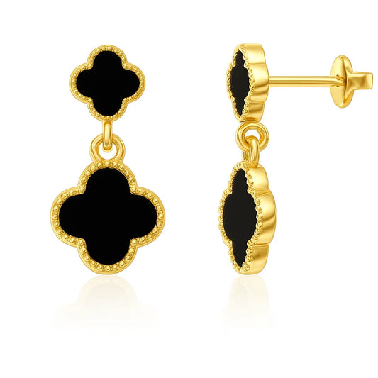 Gold earrings with black clover-shaped stones on a white background